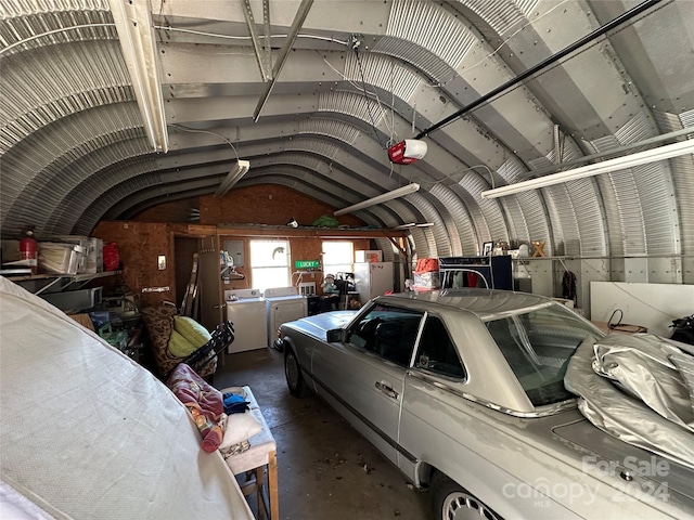 garage featuring a garage door opener and washing machine and clothes dryer