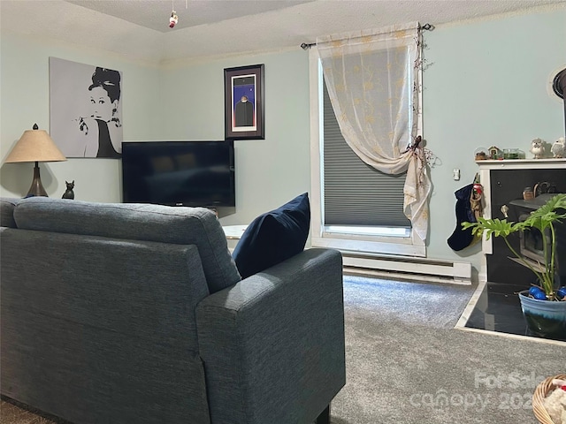 carpeted living room with a textured ceiling and a baseboard heating unit