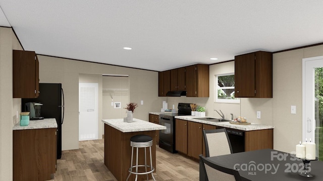 kitchen with black appliances, sink, light hardwood / wood-style floors, range hood, and a kitchen island