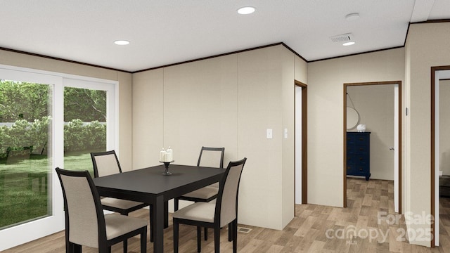 dining area with light hardwood / wood-style flooring and crown molding