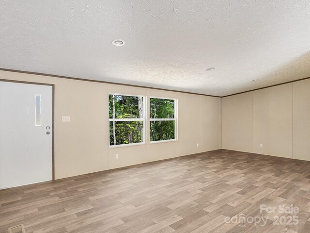 20 Windy Mountain Ln Unit 1, Hendersonville, NC 28792 - unfurnished room featuring light wood-style floors, a textured ceiling, recessed lighting, and ornamental molding