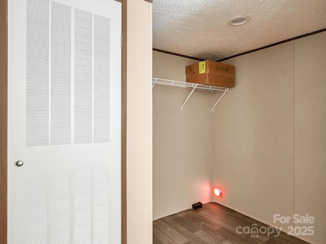 20 Windy Mountain Ln Unit 1, Hendersonville, NC 28792 - washroom with a heating unit, dark wood-style floors, a textured ceiling, and ornamental molding