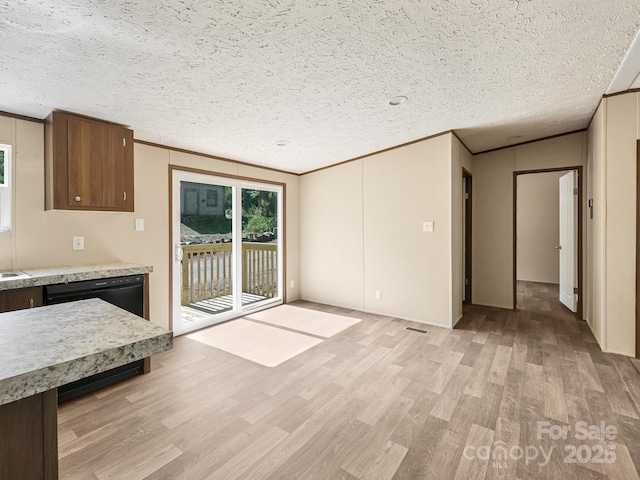 20 Windy Mountain Ln Unit 1, Hendersonville, NC 28792 - kitchen with light wood-style floors, crown molding, light countertops, black dishwasher, and a textured ceiling