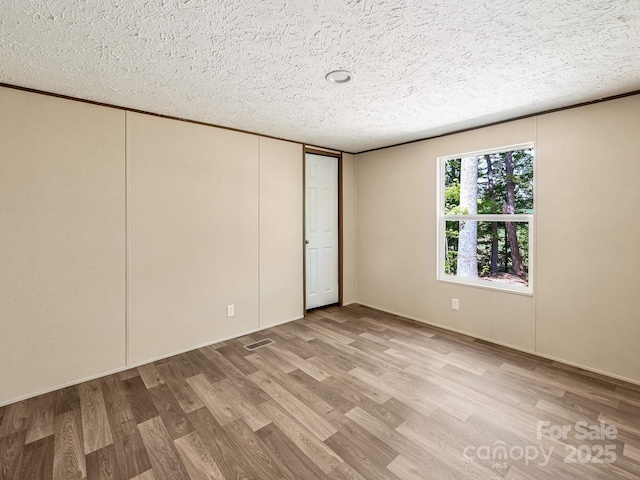 20 Windy Mountain Ln Unit 1, Hendersonville, NC 28792 - empty room with wood finished floors and a textured ceiling