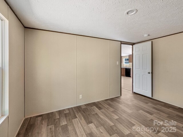 20 Windy Mountain Ln Unit 1, Hendersonville, NC 28792 - spare room featuring wood finished floors and a textured ceiling