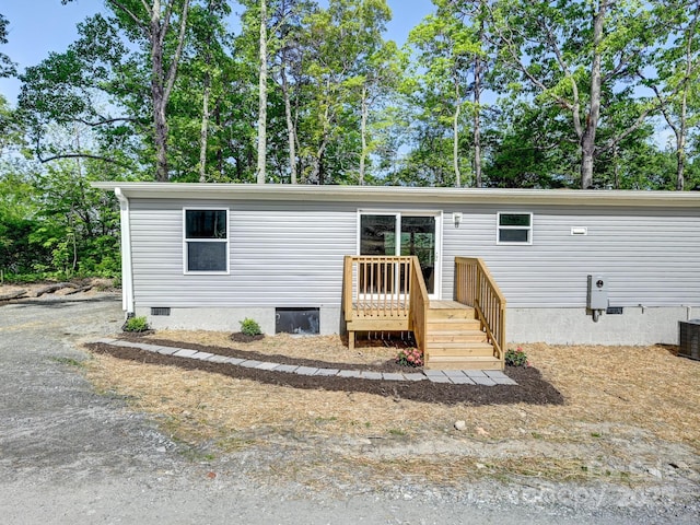 20 Windy Mountain Ln Unit 1, Hendersonville, NC 28792 - manufactured / mobile home with crawl space, a deck, and view of wooded area