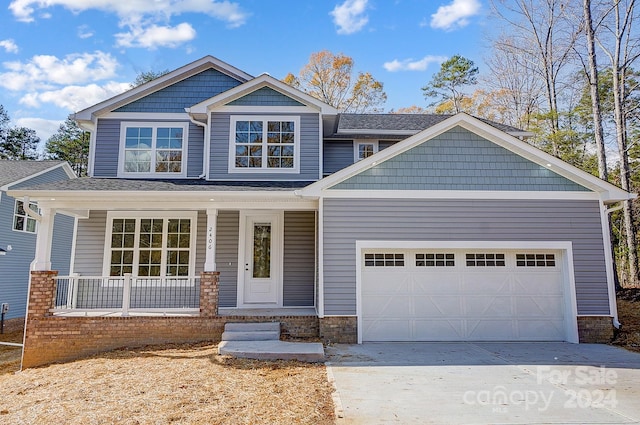 craftsman house with a garage and covered porch