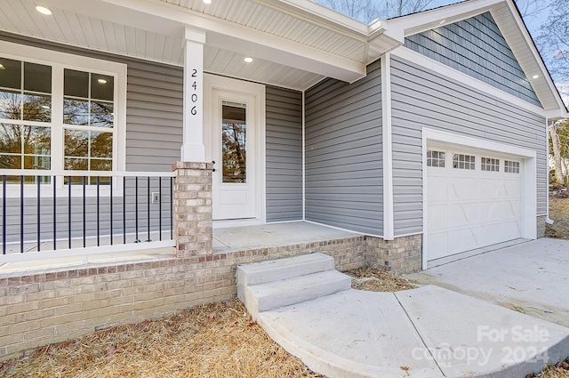 entrance to property with a porch and a garage