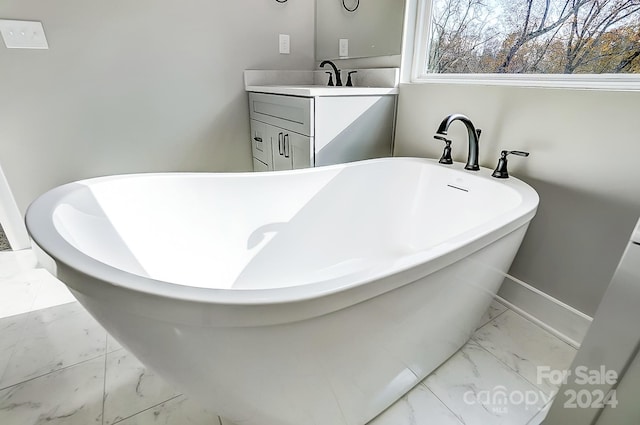 bathroom featuring a bathing tub and vanity