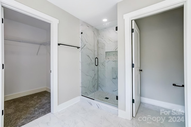 bathroom with a shower with shower door