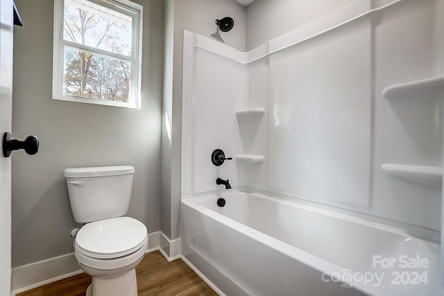 bathroom featuring hardwood / wood-style floors, toilet, and shower / bath combination