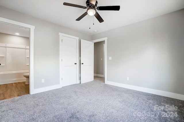 unfurnished bedroom with connected bathroom, ceiling fan, and carpet