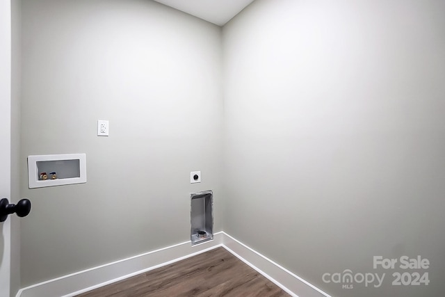 washroom featuring dark hardwood / wood-style flooring, hookup for a washing machine, and hookup for an electric dryer