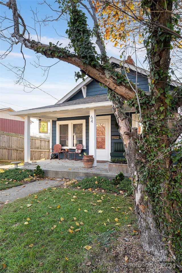 exterior space with a porch and a front lawn