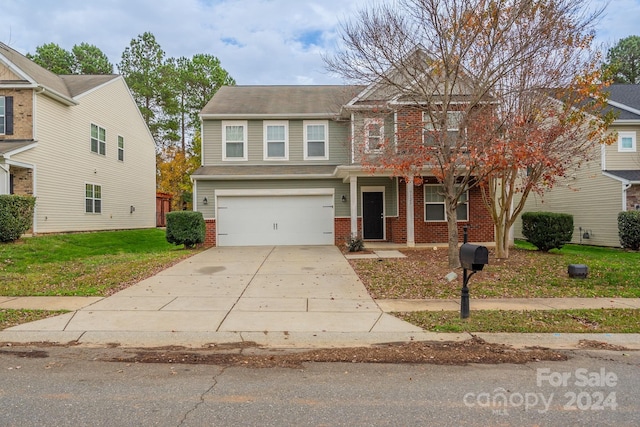 view of front of property with a garage and a front lawn