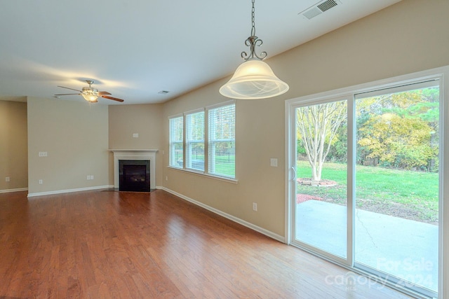 unfurnished living room featuring ceiling fan and wood-type flooring