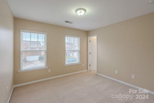 unfurnished room with light carpet