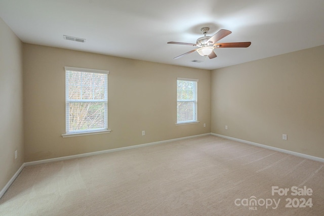 unfurnished room featuring ceiling fan and light colored carpet