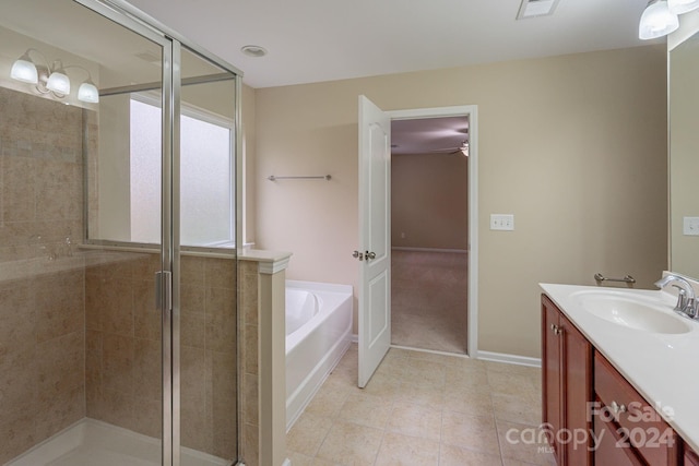 bathroom featuring tile patterned floors, vanity, and separate shower and tub