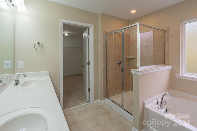 bathroom with shower with separate bathtub, vanity, and tile patterned floors