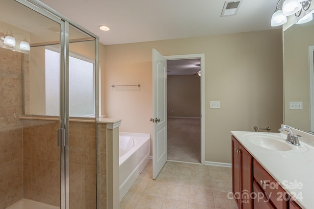 bathroom with tile patterned floors, vanity, and plus walk in shower