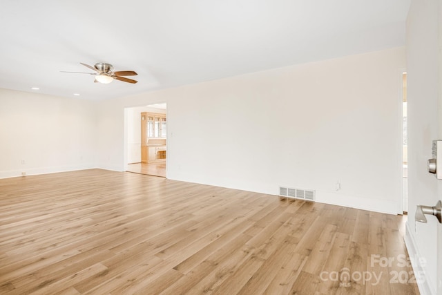 spare room with light hardwood / wood-style floors and ceiling fan