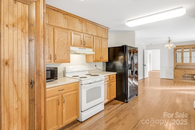 kitchen with pendant lighting, an inviting chandelier, white range, light hardwood / wood-style flooring, and black fridge with ice dispenser