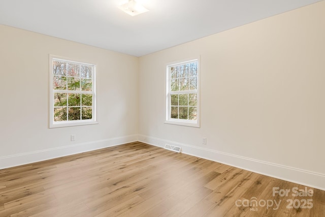 empty room with a healthy amount of sunlight and light wood-type flooring