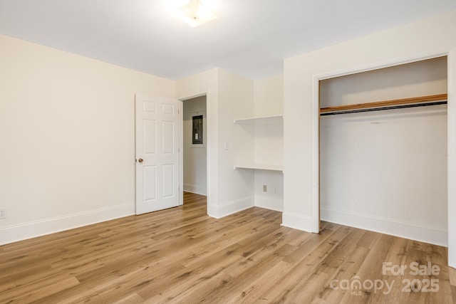 unfurnished bedroom featuring a closet and light wood-type flooring