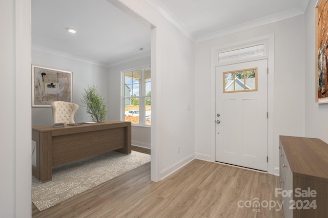 foyer featuring ornamental molding, a healthy amount of sunlight, and light hardwood / wood-style floors