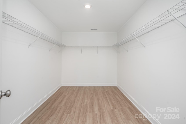 walk in closet featuring hardwood / wood-style floors