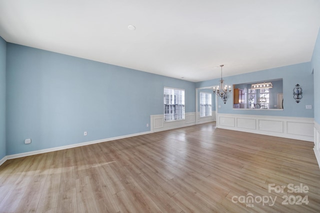 interior space featuring a chandelier and light hardwood / wood-style flooring