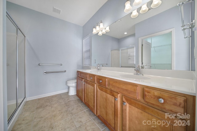 bathroom featuring vanity, tile patterned flooring, toilet, a notable chandelier, and an enclosed shower