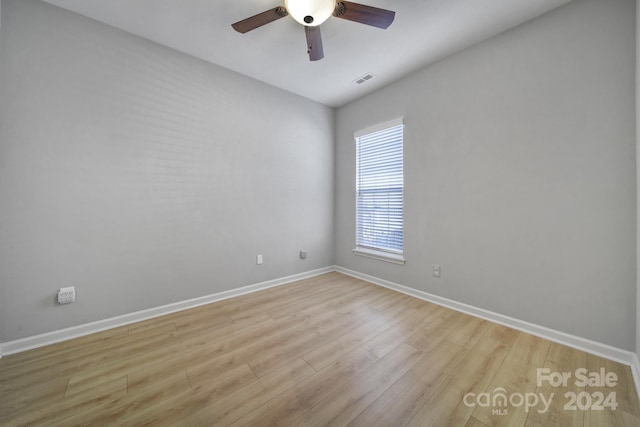 spare room with ceiling fan and light hardwood / wood-style flooring