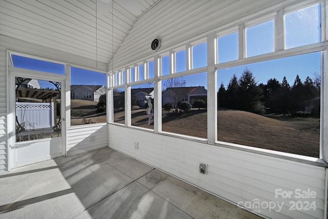 unfurnished sunroom with lofted ceiling