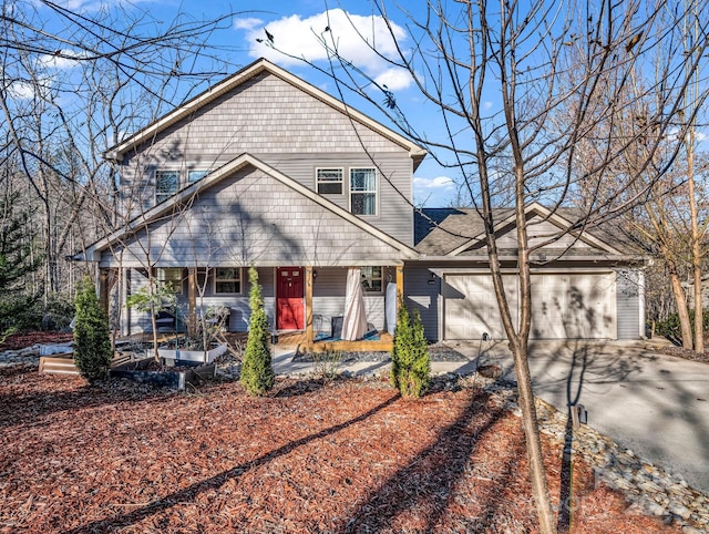 view of property featuring a porch and a garage