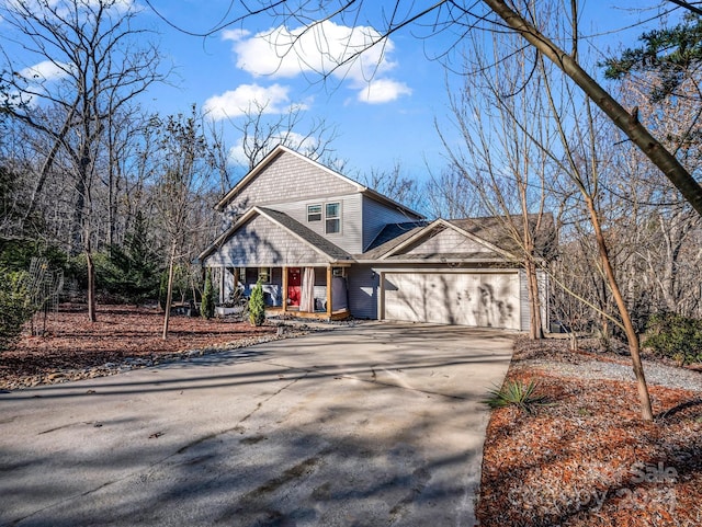 view of front property with a porch and a garage