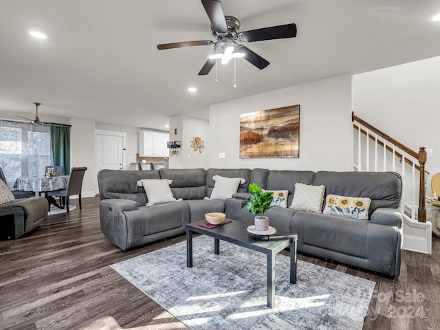 living room featuring dark hardwood / wood-style flooring and ceiling fan