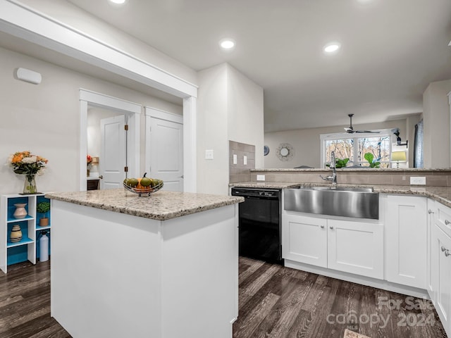 kitchen featuring black dishwasher, dark hardwood / wood-style floors, and white cabinetry