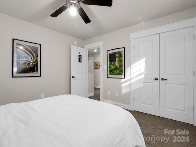 bedroom featuring ceiling fan, dark carpet, and a closet