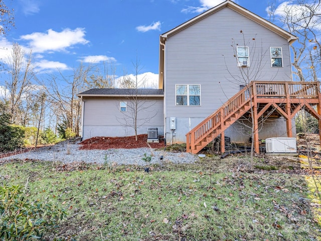 rear view of house with central air condition unit and a wooden deck