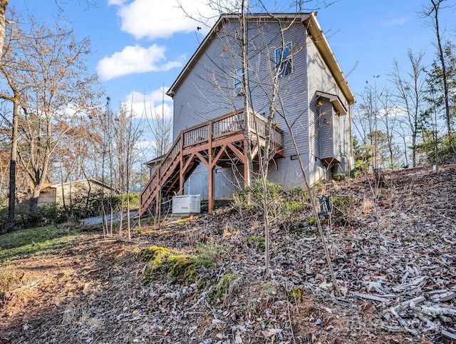 rear view of property featuring a deck