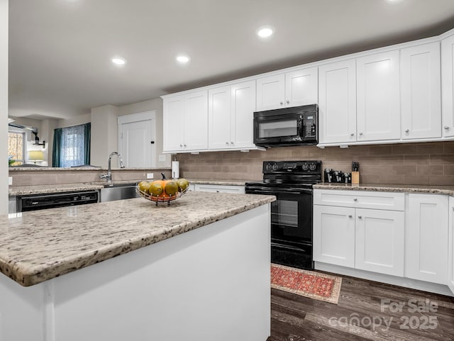 178 Flynn Ct, Lake Lure, NC 28746 - kitchen with a kitchen island, dark wood-style floors, white cabinetry, backsplash, and black appliances