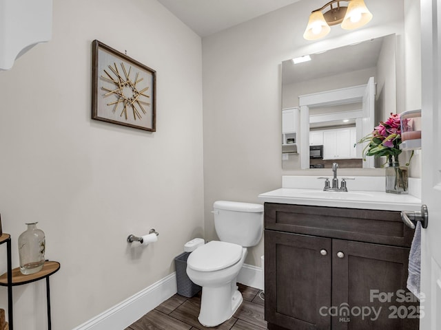 178 Flynn Ct, Lake Lure, NC 28746 - half bathroom with toilet, baseboards, wood finished floors, and vanity
