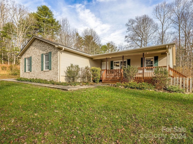 single story home featuring covered porch and a front lawn