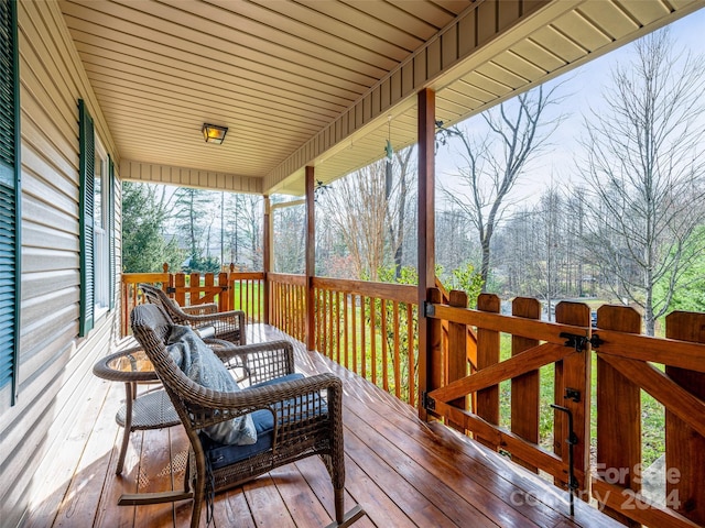 wooden terrace featuring covered porch