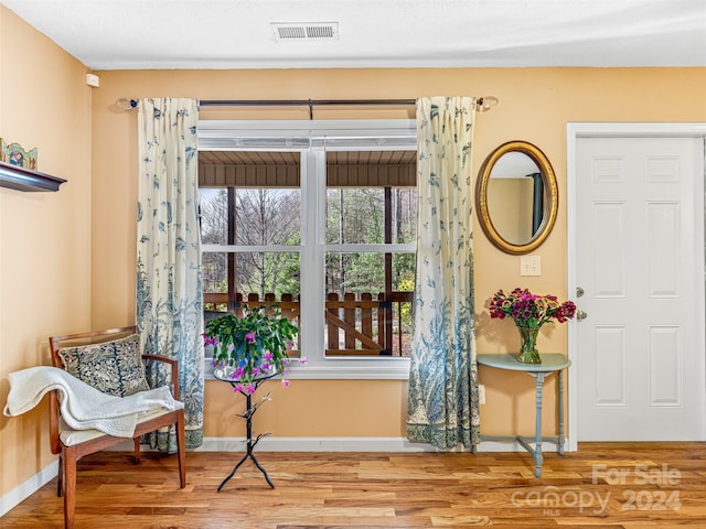 living area with hardwood / wood-style flooring