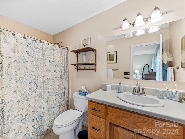 bathroom with tile patterned floors, vanity, and toilet