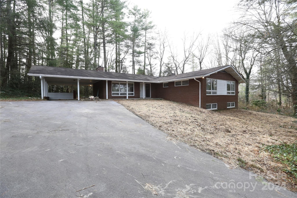 ranch-style house featuring a carport