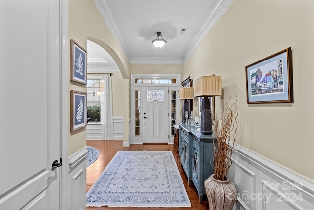 entryway featuring crown molding and hardwood / wood-style floors